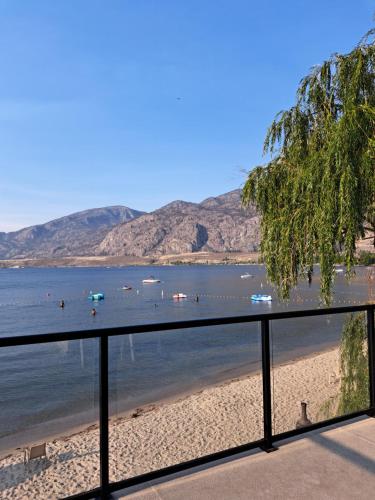 a view of a beach with boats in the water at Richter Pass Beach Resort in Osoyoos