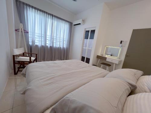 a hotel room with two beds and a television at Ins Apartment Langkawi Simfoni Beliza KUAH in Kuah