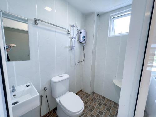 a white bathroom with a shower and a toilet at Ins Apartment Langkawi Simfoni Beliza KUAH in Kuah