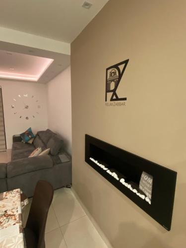 a living room with a couch and a fireplace at Relax Zabbar in Żabbar