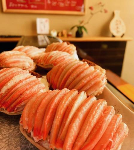 a bunch of hot dogs on a plate on a table at ひがし茶屋街らしく金沢 Hotel Rashiku kanazawa in Kanazawa