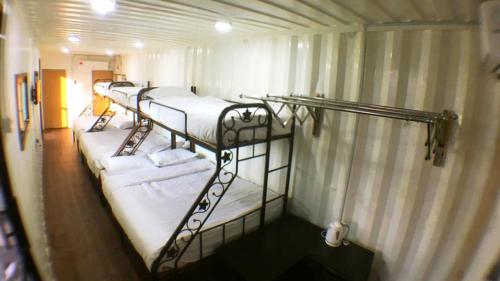 a group of bunk beds in a room at Sand Dune Villa in Kampong Beting Lintang