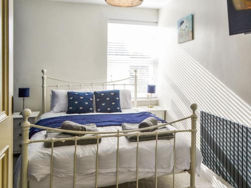 Dove Cottage-number 16 في بلفورد: غرفة نوم بسرير وبطانيات ووسائد زرقاء