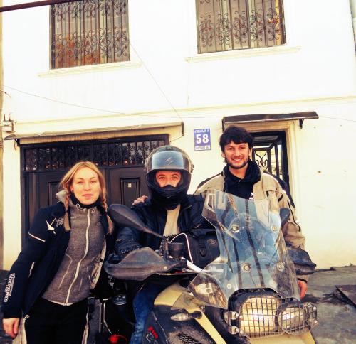 a man and a woman standing next to a motorcycle at Nitsa Guest House in Gori