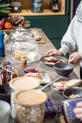 a table topped with plates of food on top at Foxfires Private Boutique Guesthouse in Levi