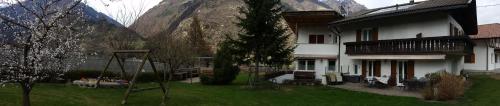 a house with a playground in front of a mountain at Gaulbachhof in Naturno
