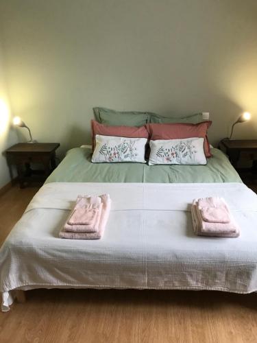 a bed with two towels on top of it at Le Rameau in Sainte-Menehould