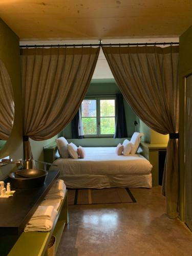 une chambre avec deux lits et une fenêtre dans l'établissement Le Bois des Chambres, à Chaumont-sur-Loire