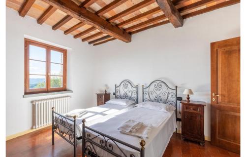a bedroom with a bed and a wooden floor at Mandorli in Monte Santa Maria Tiberina