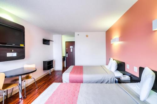 a hotel room with two beds and a desk at Motel 6-Lansing, IL - Chicago South in Lansing