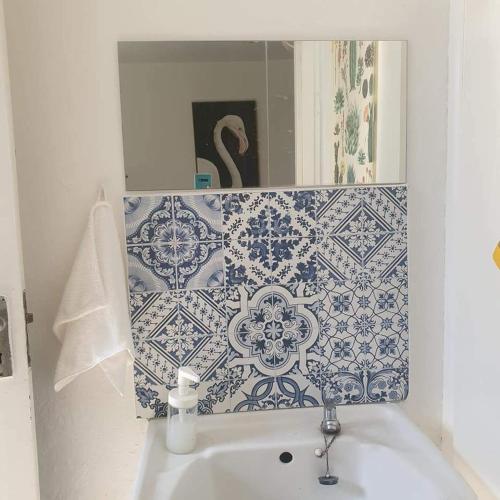 a bathroom with blue and white tiles on the wall at Homestay Cempaka Star in Ipoh