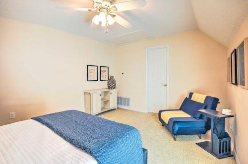 a bedroom with a bed and a blue chair at Beautiful Montgomery Home with Lakefront Deck! in Montgomery
