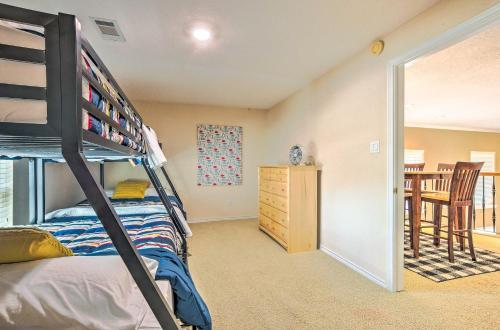 a bedroom with a bunk bed and a dining room at Beautiful Montgomery Home with Lakefront Deck! in Montgomery