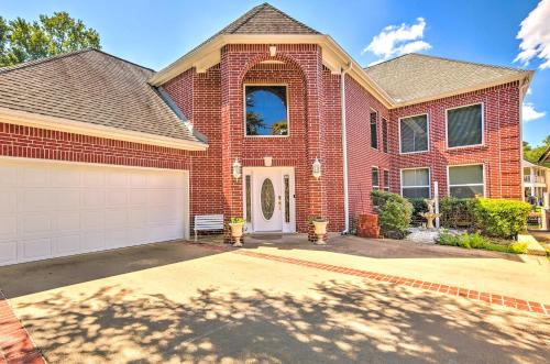 a red brick house with a white garage at Beautiful Montgomery Home with Lakefront Deck! in Montgomery