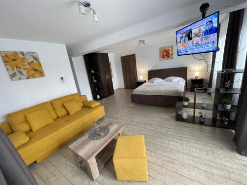 a living room with a couch and a bed at Casa Valentina in Cristian