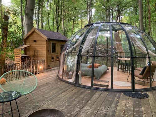 a gazebo on a wooden deck with a house at Le Dôme de Namur - Une nuit insolite dans les bois in Champion