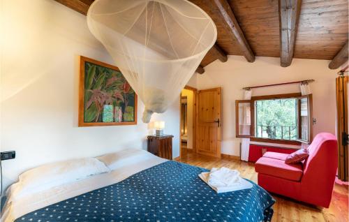 1 dormitorio con 1 cama y 1 silla roja en Villacolli, en Valnogaredo