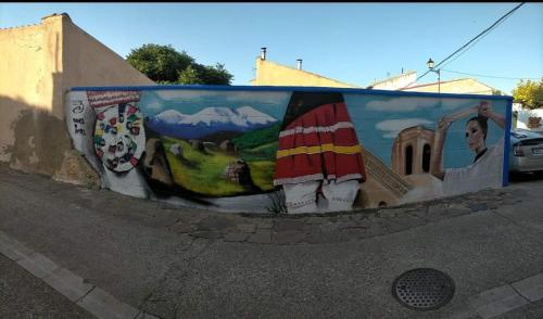 a mural on the side of a wall at CASA RURAL EL CAIDERÓN in Ambel