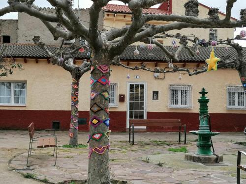 a tree with decorations on it in front of a building at CASA RURAL EL CAIDERÓN in Ambel