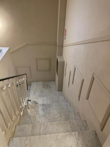 a staircase in a room with a stair case at Hotel Lukas Vegetarian & Vegan in Viareggio