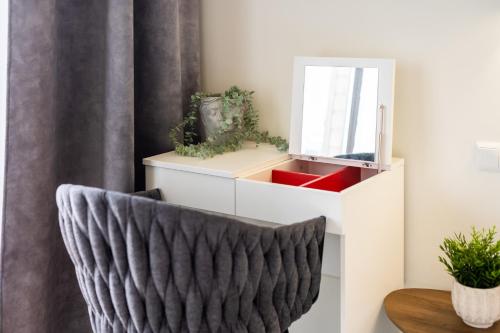 a room with a chair and a mirror at Apartament Baltic Plaza 316 in Kołobrzeg