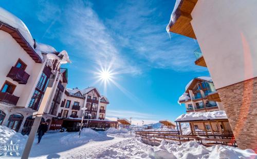 a city street covered in snow with buildings at New Gudauri Twins Mountain view in Gudauri