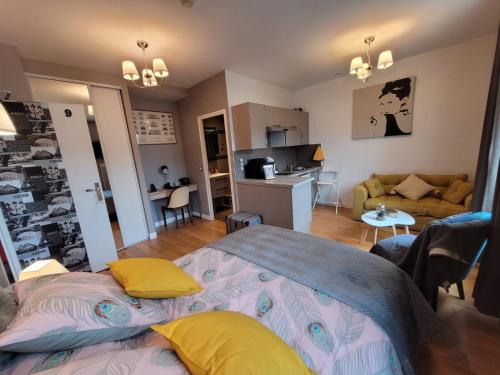 a bedroom with a bed and a living room at Hotel Oh Sevres Autrement in Sèvres