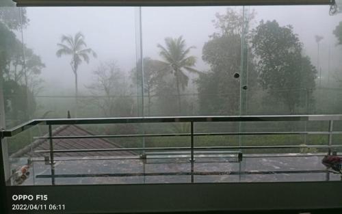 a view of a tennis court in the rain at Divine View Holyday Home (Homestay) in Kalpetta