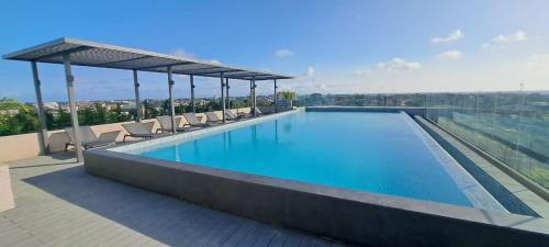 a swimming pool on the roof of a building at The Lennox Luxury Apartment in Accra