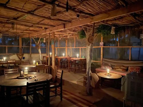 Moon_Valley_Siwa في سيوة: مطعم فيه طاولات وكراسي في الغرفة