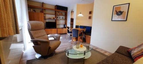 a living room with a couch and a table at Weinmanns Wildgatter in Grafenwiesen