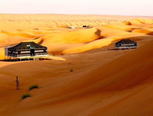 a man standing in the middle of a desert at Rashid Desert Private Camp in Bidiyah