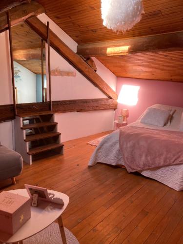 a bedroom with a bed in a room with wooden ceilings at Maison Fontrabiouse in Fontrabiouse