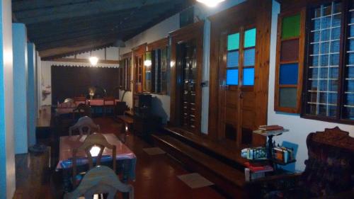 a living room with wooden floors and windows and a room at Sea Hut Homestay in Cochin