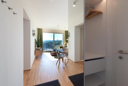 a living room with a table and a dining room at Grüne Oase an der Therme in Vienna