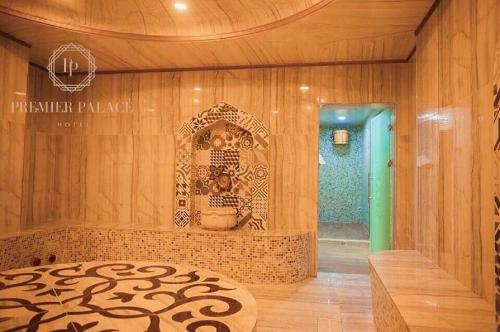 a room with a wooden wall with a bed in it at Premier Palace Baku in Baku