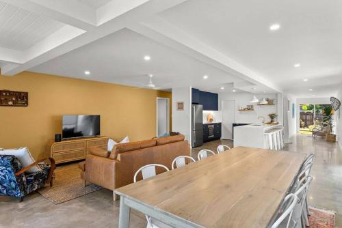 a living room with a wooden table and a couch at Salty Crab Bungalow in Lennox Head
