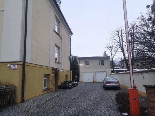 a car parked on a street next to a building at Studia Pasieka in Opole