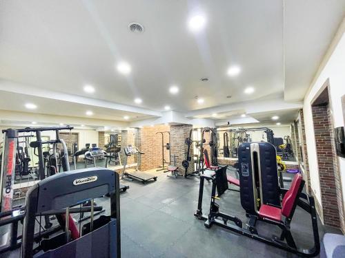 a gym with several treadmills and exercise bikes at Premier Palace Baku in Baku