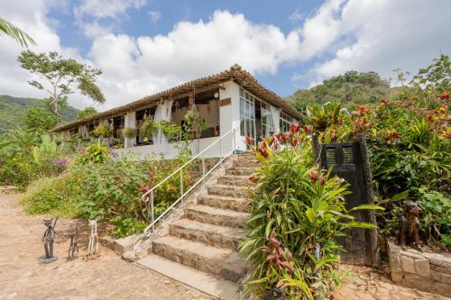 a house with stairs leading up to it at Pousada Le Monte Cristo in Guaramiranga