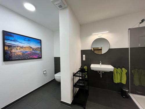 a bathroom with a sink and a toilet at Ferienwohnungen an der Salvatorkirche - Exklusiv-Apartments mit Terrasse in Coburg