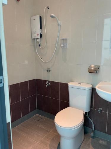 a bathroom with a toilet and a shower at Guest House "Feel at Home" Near A Famosa Fortress & Stadhuys in Melaka