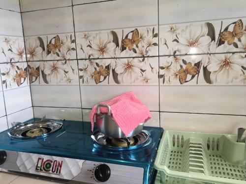 a kitchen counter with a pot on a stove at Residence MaryHouse - Free Breakfast and Taxi From Airport in Cotonou