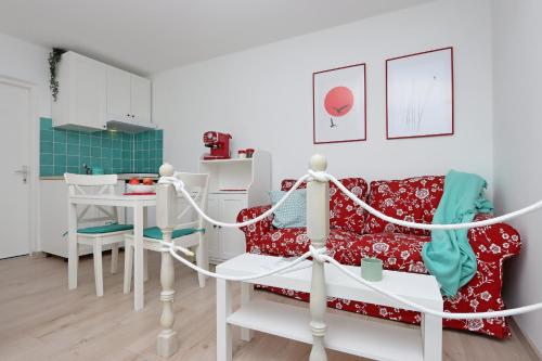 a living room with a couch and a table at Sha La La - Charming, unique studio in a historic building next to a castle, WIFI, smart TV, washer-dryer in Bakar