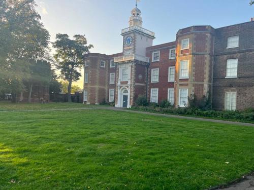 a large brick building with a clock tower on it at Castle Court Apartment in London