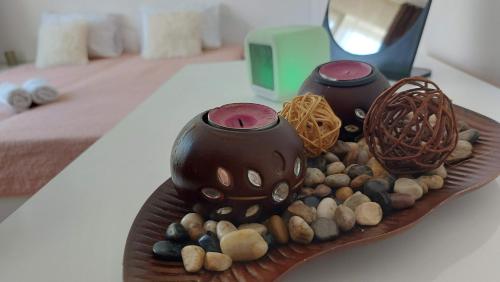 a plate with two vases and rocks on a table at 3 Rooms Apartment, Top Center, 1st Floor, AUBG, WiFi, PC i5 SSD, Tablet, AndroidMiTvBox, 3 LED TVs 200 Channels, Long Terrace, Self-Easy-Late Check-in, Stay Before Greece in Blagoevgrad