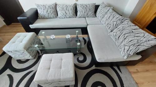 a living room with a couch and a coffee table at 3 Rooms Apartment, Top Center, 1st Floor, AUBG, WiFi, PC i5 SSD, Tablet, AndroidMiTvBox, 3 LED TVs 200 Channels, Long Terrace, Self-Easy-Late Check-in, Stay Before Greece in Blagoevgrad