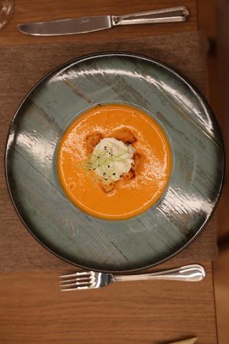 a plate with a bowl of food on a table at City Hotel Glarnerland in Näfels