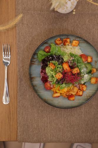 a plate of food on a table with a fork at City Hotel Glarnerland in Näfels