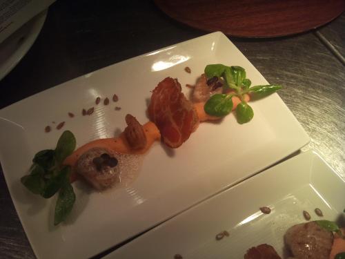 a white plate with some food on a table at Hotel en Restaurant de Stripe in Wijnjewoude